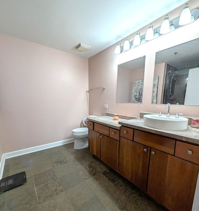 bathroom featuring vanity, a shower, and toilet