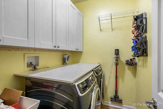 clothes washing area with independent washer and dryer and cabinets