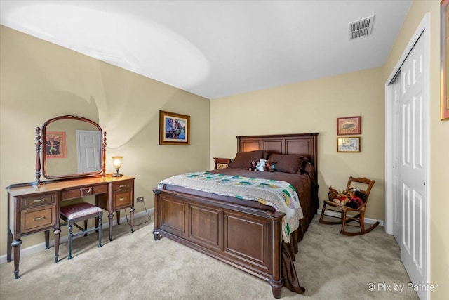 bedroom with light colored carpet and a closet