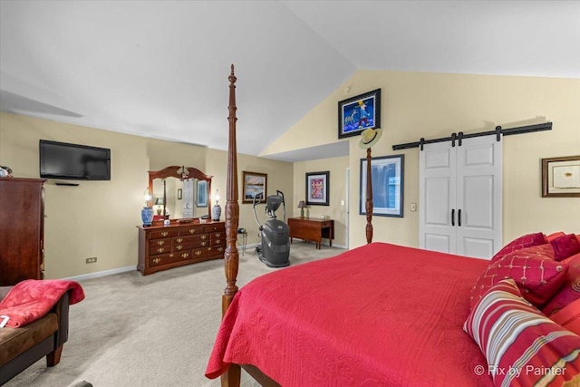 carpeted bedroom with vaulted ceiling and a barn door