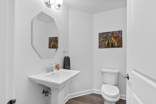 bathroom with wood-type flooring and toilet