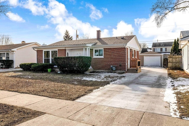 view of front of house featuring a garage and an outbuilding