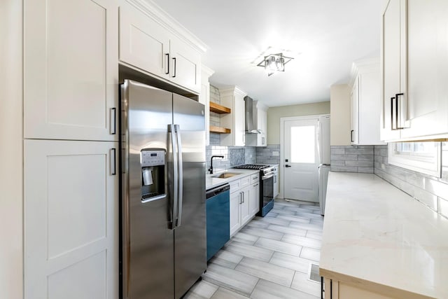 kitchen with wall chimney exhaust hood, white cabinetry, tasteful backsplash, light stone counters, and stainless steel appliances