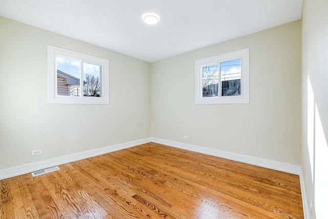 unfurnished room featuring light hardwood / wood-style flooring and a healthy amount of sunlight