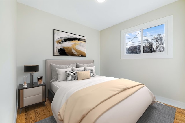 bedroom with hardwood / wood-style floors