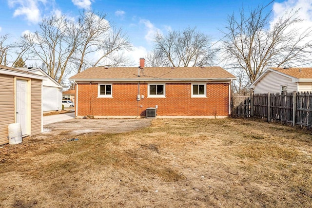 back of house with a yard and central AC unit