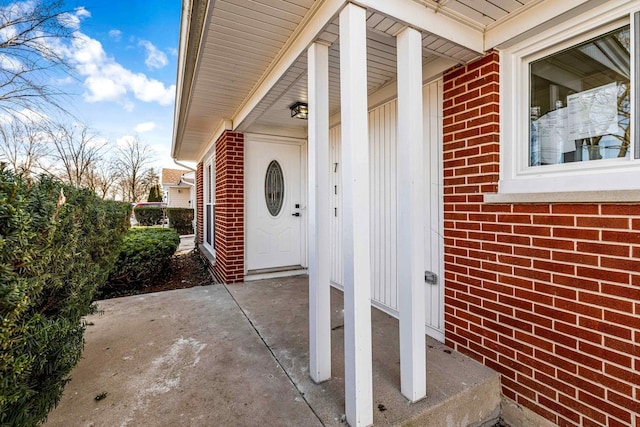 view of exterior entry featuring a patio area