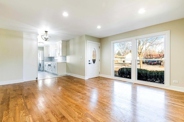 interior space with a chandelier and light hardwood / wood-style flooring