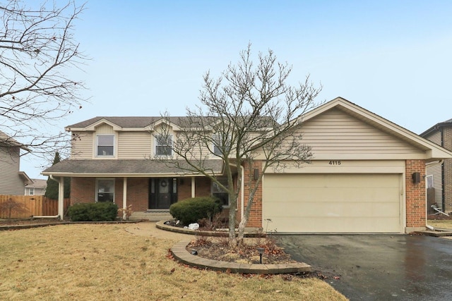 view of front of house featuring a porch, a garage, and a front yard