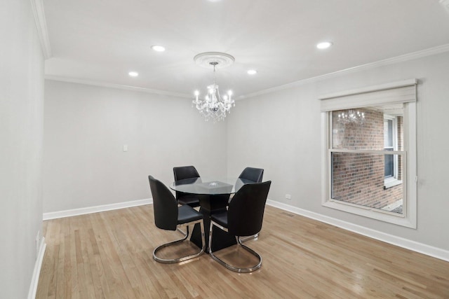 dining area with ornamental molding, light hardwood / wood-style flooring, and a notable chandelier