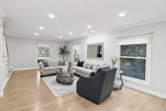 living room featuring light hardwood / wood-style flooring and ornamental molding