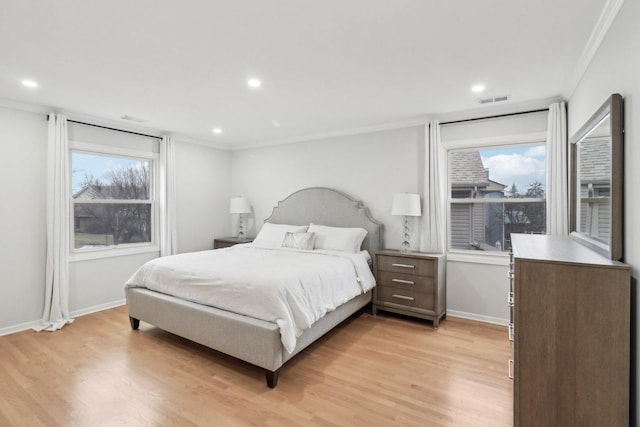 bedroom featuring crown molding and light hardwood / wood-style floors