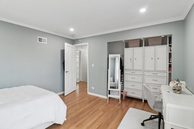 bedroom featuring light hardwood / wood-style flooring and ornamental molding