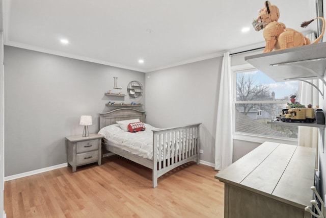 bedroom featuring light hardwood / wood-style flooring and ornamental molding