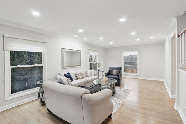 living room featuring ornamental molding and light hardwood / wood-style floors