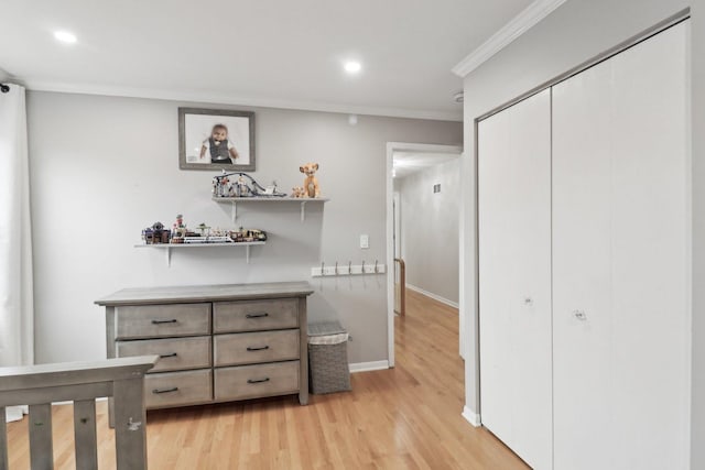 interior space with ornamental molding and light hardwood / wood-style floors