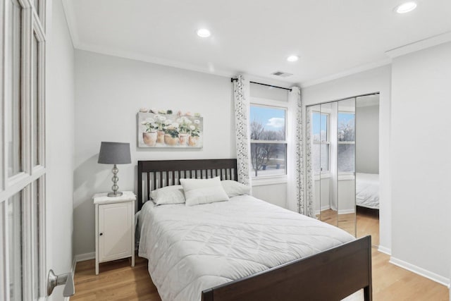 bedroom with crown molding and hardwood / wood-style floors