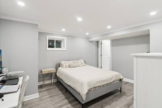 bedroom featuring crown molding and light wood-type flooring