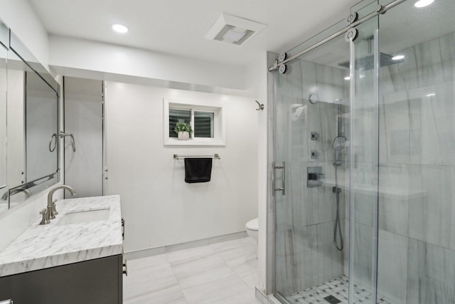 bathroom featuring vanity, toilet, and a shower with shower door