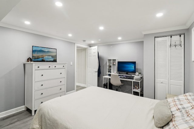 bedroom featuring crown molding, wood-type flooring, and a closet