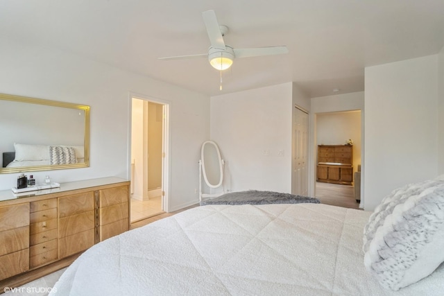 bedroom with ensuite bath, ceiling fan, and a closet