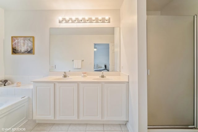 bathroom featuring tile patterned floors, shower with separate bathtub, and vanity