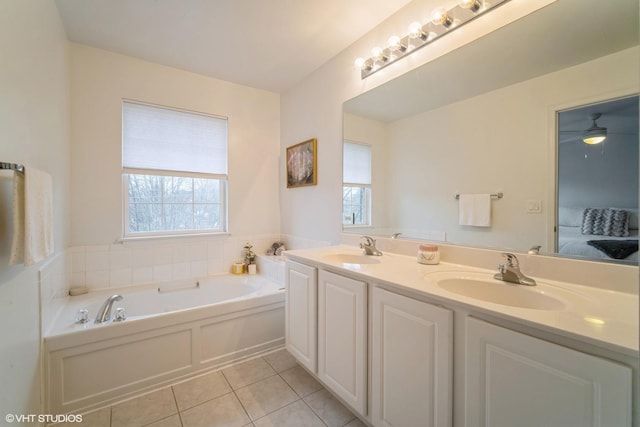 bathroom featuring a tub to relax in, vanity, tile patterned flooring, and a wealth of natural light