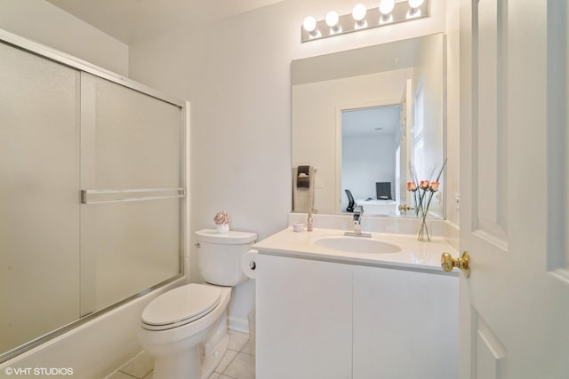 full bathroom with tile patterned flooring, vanity, shower / bath combination with glass door, and toilet