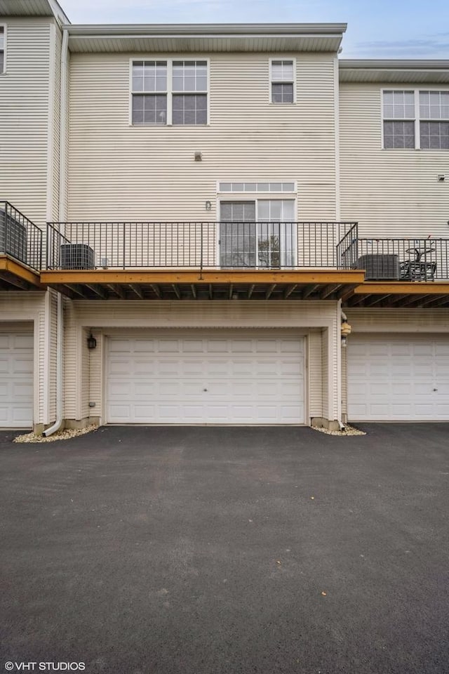 rear view of property with a garage