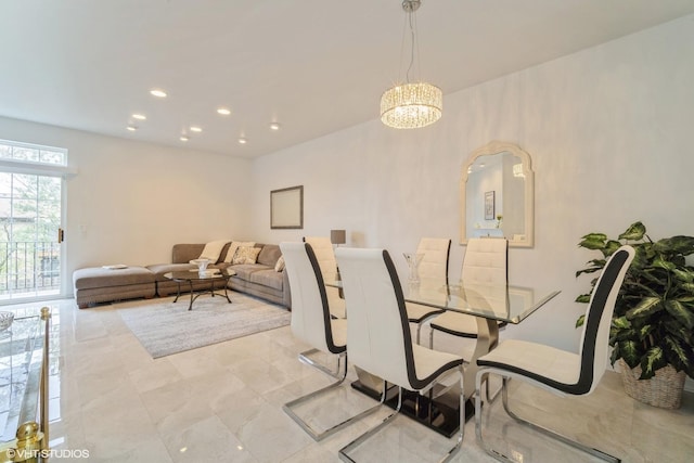 dining area featuring an inviting chandelier