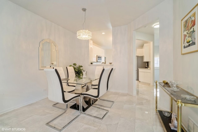 dining area featuring an inviting chandelier