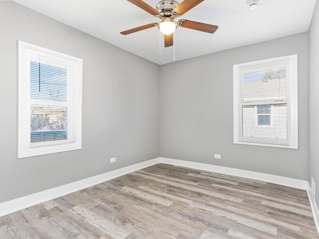 empty room with ceiling fan and light hardwood / wood-style floors