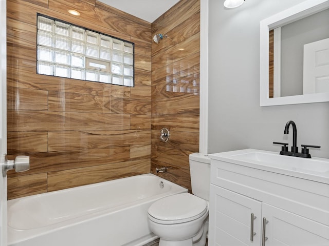 full bathroom with tiled shower / bath combo, vanity, and toilet