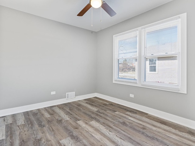 empty room featuring hardwood / wood-style floors and ceiling fan