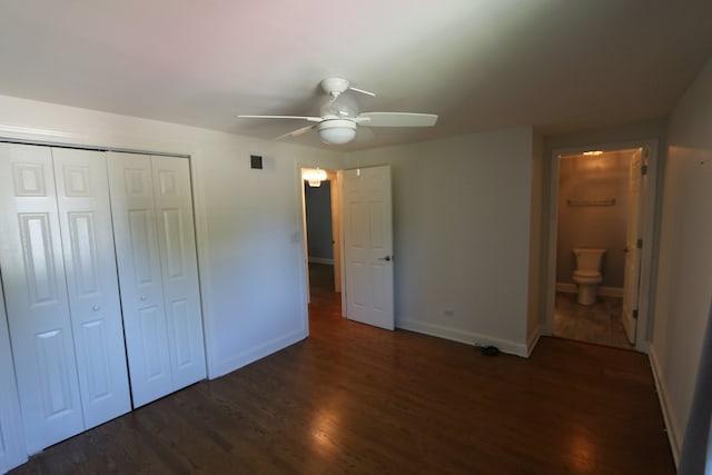 unfurnished bedroom featuring connected bathroom, dark hardwood / wood-style floors, a closet, and ceiling fan