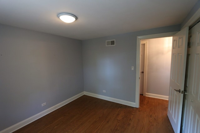 unfurnished room featuring dark hardwood / wood-style flooring