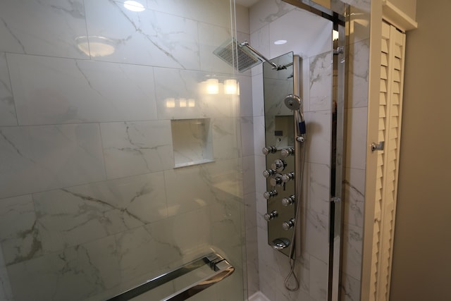 bathroom with a shower with door