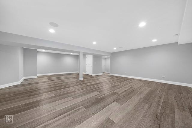 basement with hardwood / wood-style flooring