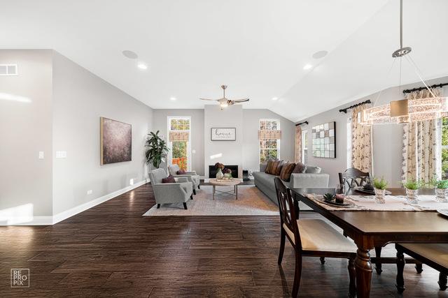 dining room featuring ceiling fan, vaulted ceiling, and dark hardwood / wood-style flooring