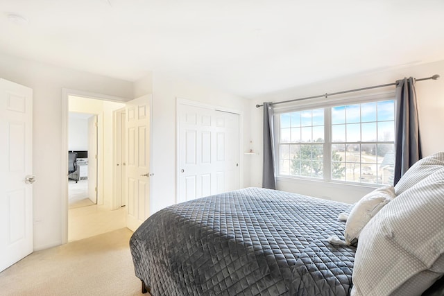 bedroom with light colored carpet and a closet