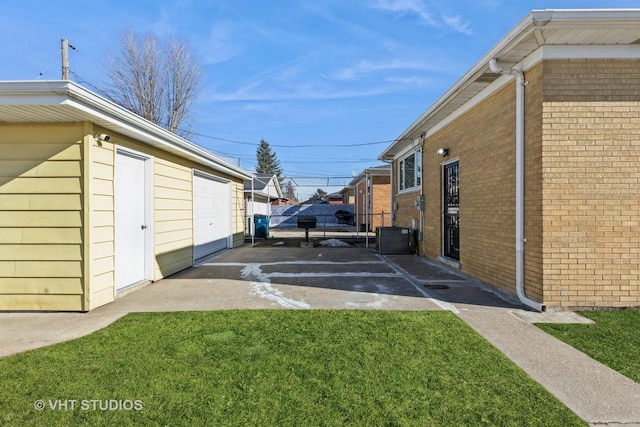 view of yard featuring a garage and cooling unit