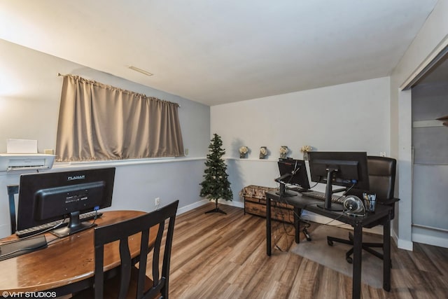 home office with hardwood / wood-style flooring