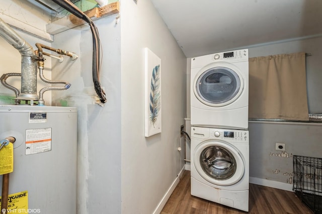 clothes washing area with gas water heater, stacked washing maching and dryer, and dark hardwood / wood-style floors