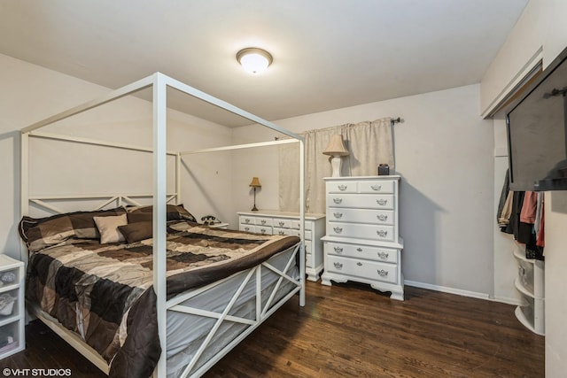 bedroom with dark hardwood / wood-style flooring