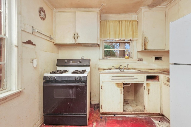 kitchen featuring sink, white appliances, and cream cabinets