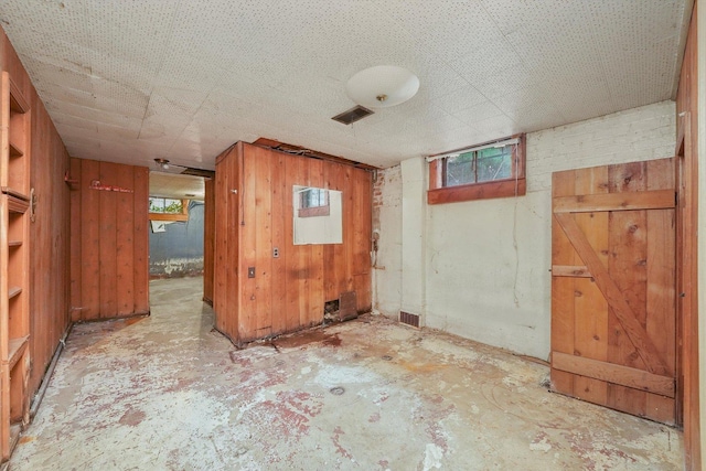 unfurnished room with wooden walls