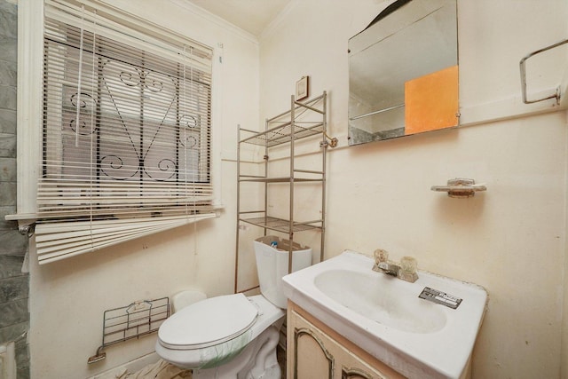 bathroom featuring crown molding, vanity, and toilet