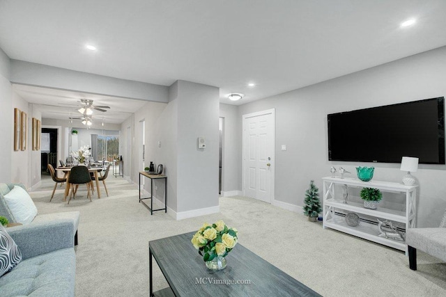 living room featuring light colored carpet and ceiling fan