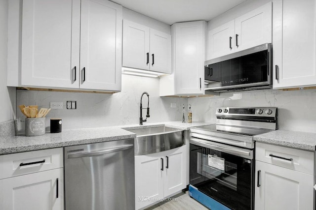 kitchen with stainless steel appliances and white cabinets