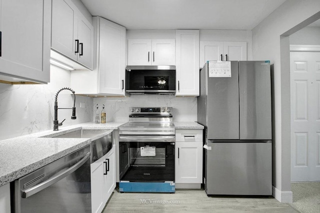 kitchen featuring sink, stainless steel appliances, and white cabinets